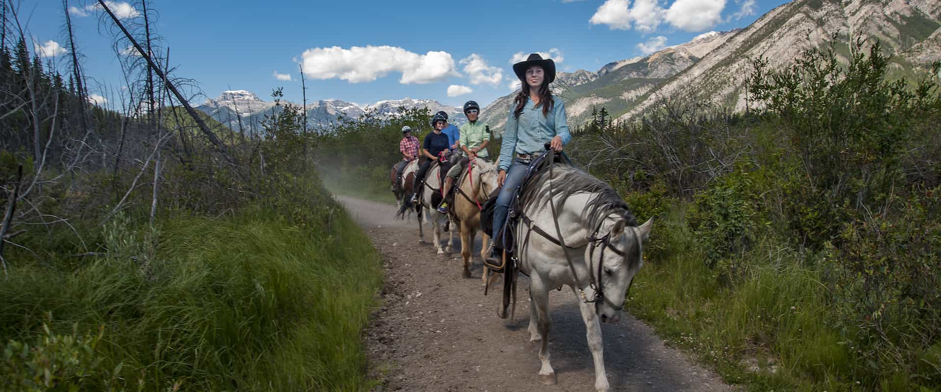 Follow your guide on a scenic Bow River horseback ride with Banff Trail Riders in the Canadian Rockies
